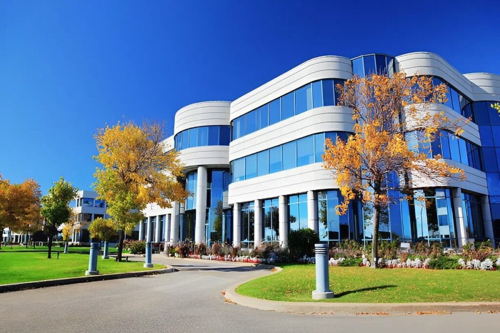 Commercial building with clean white facade and large glass windows by an exterior painter in Tampa, FL