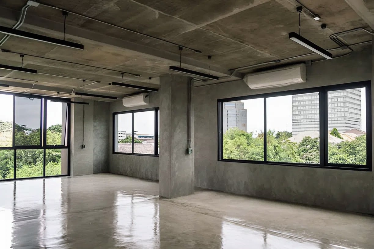 Commercial office interior with polished concrete floors and smooth gray walls by a repaint specialist in Tampa, FL