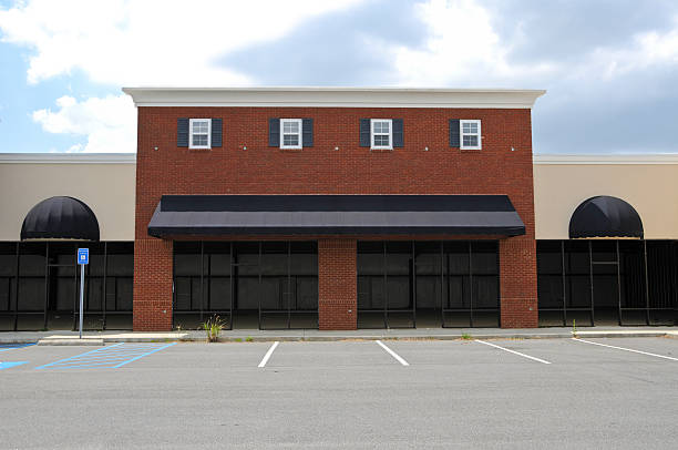 Commercial exterior with brick façade and black awnings by a painting company in Polk County, FL