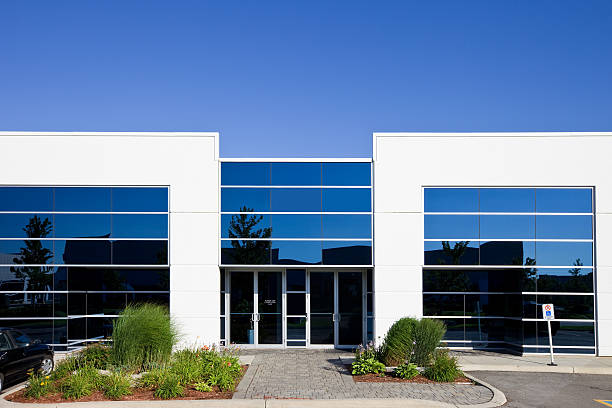 Modern commercial building with reflective glass windows and landscaped grounds by an exterior painter in Tampa, FL.