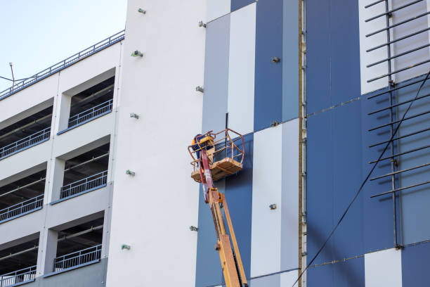Commercial building exterior painting with a boom lift by an exterior painter in Tampa, FL.